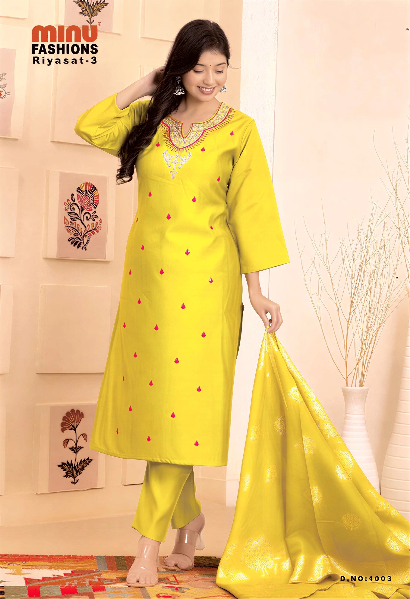 Woman wearing a yellow traditional outfit with a matching dupatta in a decorated room.