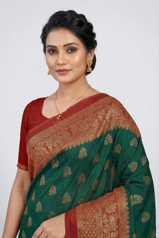 Woman wearing a green and red saree with a white background