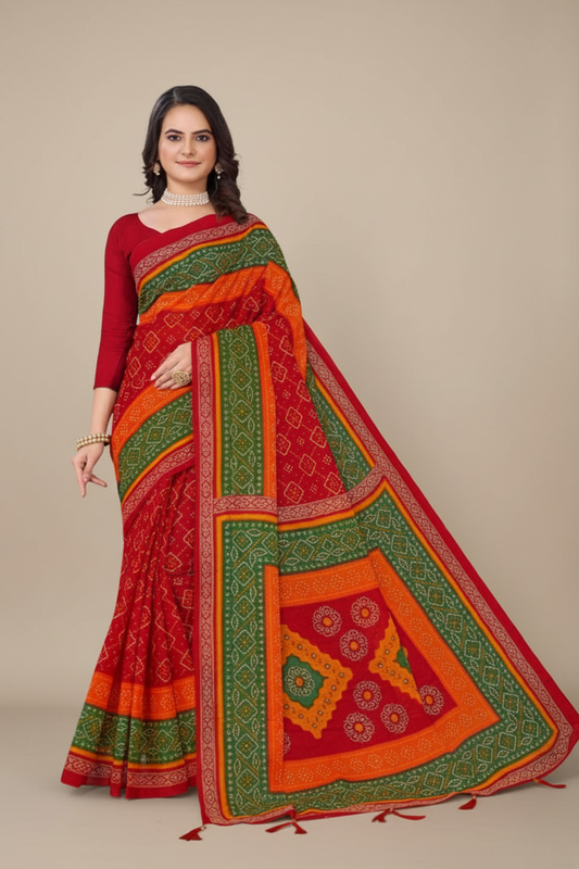 Woman wearing a red and orange saree with green patterns on a beige background