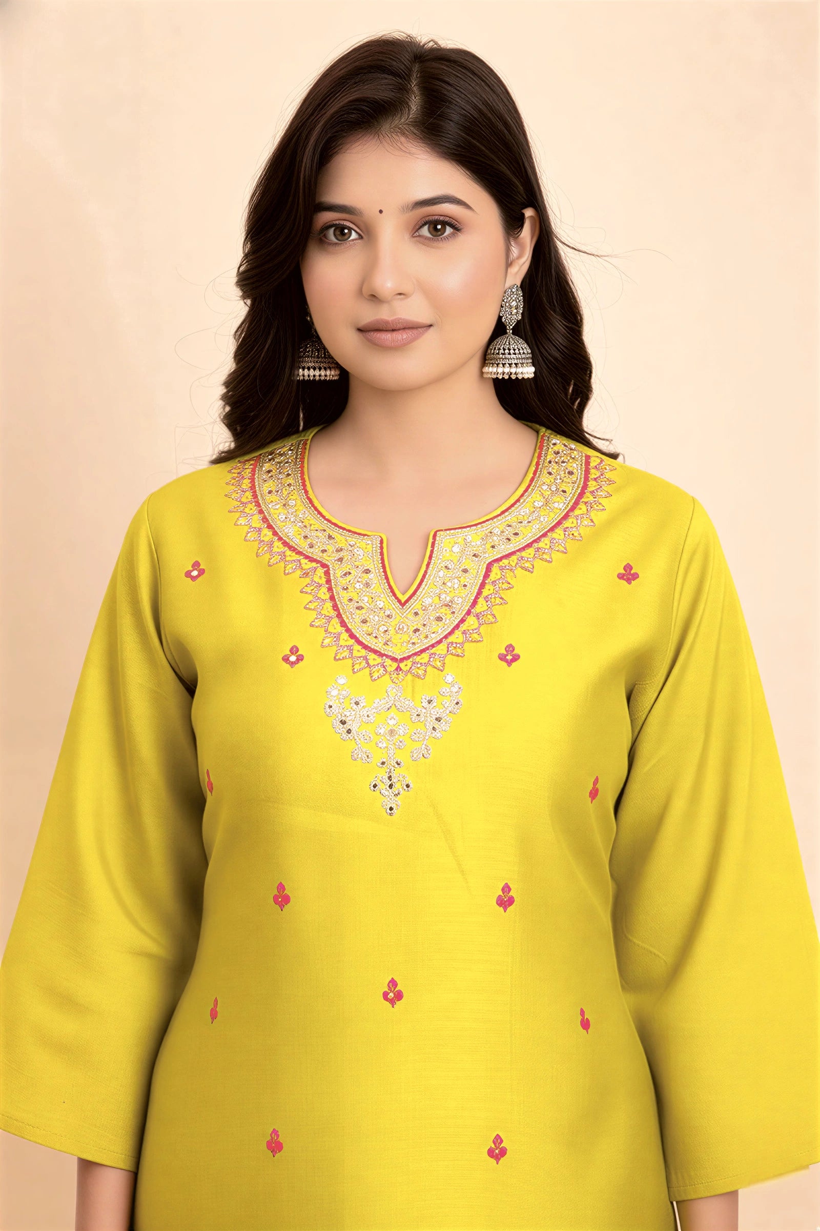 Woman wearing a yellow embroidered kurta against a beige background