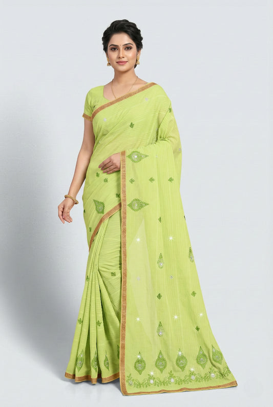 Woman wearing a light green saree with a white background