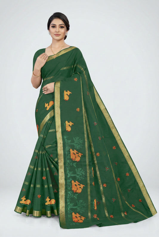 Woman wearing a green saree with gold and orange patterns on a white background