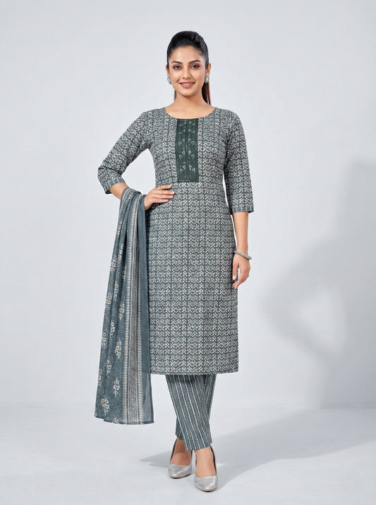 Woman wearing a gray patterned kurta with matching pants and dupatta on a white background