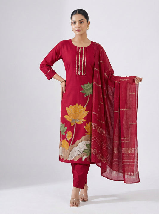 Woman wearing a red floral outfit with a matching dupatta on a white background